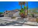 House with palm trees and a gray garage door at 4773 Sarazen Cir, Las Vegas, NV 89103