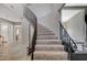 Elegant curved staircase with a metal railing at 4773 Sarazen Cir, Las Vegas, NV 89103