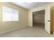 Bright bedroom features light wood floors, window with blinds, and open doorway to another room at 523 Painted Cloud Pl, Las Vegas, NV 89144