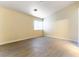 Bright bedroom with wood-look flooring, a window for natural light, and neutral wall color at 523 Painted Cloud Pl, Las Vegas, NV 89144