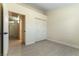 Bright bedroom with wood-look floors and closet; hallway and additional bedrooms are accessible from the room at 523 Painted Cloud Pl, Las Vegas, NV 89144