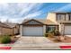 Charming single-Gathering home featuring a two-car garage, desert landscaping, and a well-maintained exterior at 523 Painted Cloud Pl, Las Vegas, NV 89144