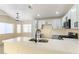 Modern kitchen featuring white cabinets, quartz countertops, stainless steel appliances, and a large island at 523 Painted Cloud Pl, Las Vegas, NV 89144