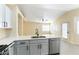 Bright kitchen featuring white cabinets, quartz countertops, and stainless steel appliances at 523 Painted Cloud Pl, Las Vegas, NV 89144