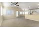 Open-concept living room with vaulted ceilings, ceiling fan, kitchen, and lots of natural light at 523 Painted Cloud Pl, Las Vegas, NV 89144