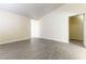 Spacious and bright living room with light-toned floors, white baseboards and large windows at 523 Painted Cloud Pl, Las Vegas, NV 89144
