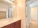 Bathroom with vanity, mirror and access to hallway at 6412 Moss Agate Dr, Las Vegas, NV 89131