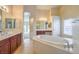 Elegant bathroom with soaking tub, double vanity, and separate shower at 6412 Moss Agate Dr, Las Vegas, NV 89131
