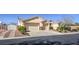 Two-car garage with brick driveway and landscaping at 6412 Moss Agate Dr, Las Vegas, NV 89131