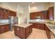 Island kitchen with granite countertops and wood cabinets at 6412 Moss Agate Dr, Las Vegas, NV 89131