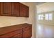 Well-appointed pantry with wood cabinets and view to dining area at 6412 Moss Agate Dr, Las Vegas, NV 89131