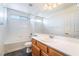 Bathroom showcasing a single vanity, large mirror, and shower-tub combo at 7524 Schuders Ave, Las Vegas, NV 89178