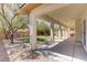 Inviting covered back patio with string lights overlooking the xeriscaped backyard at 8005 Egypt Meadows Ave, Las Vegas, NV 89178