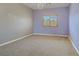 Bedroom with gray and lavender walls, carpet floors, and a chandelier at 8005 Egypt Meadows Ave, Las Vegas, NV 89178
