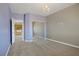 Neutral toned bedroom with a chandelier and large mirrored closet for ample storage at 8005 Egypt Meadows Ave, Las Vegas, NV 89178