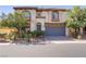 Charming two-story home featuring a tile roof, arched windows and a well-manicured front yard at 8005 Egypt Meadows Ave, Las Vegas, NV 89178