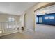 Carpeted hallway with an arched doorway to a blue bedroom and views to the lower floor at 8005 Egypt Meadows Ave, Las Vegas, NV 89178