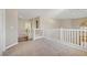Spacious carpeted hallway with views of the staircase and a window with shutter at 8005 Egypt Meadows Ave, Las Vegas, NV 89178