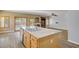 Open kitchen with island, granite countertops, stainless sink, and wood flooring at 8005 Egypt Meadows Ave, Las Vegas, NV 89178