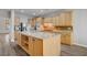 Spacious kitchen featuring an island with bar seating, wood cabinets, and stainless steel appliances at 8005 Egypt Meadows Ave, Las Vegas, NV 89178