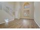 Inviting living room featuring wood floors, high ceilings, staircase and an abundance of natural light at 8005 Egypt Meadows Ave, Las Vegas, NV 89178