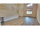 Bright living room featuring hardwood floors, staircase, and large windows offering plenty of natural light at 8005 Egypt Meadows Ave, Las Vegas, NV 89178