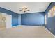 Large carpeted primary bedroom with connecting room and shuttered windows at 8005 Egypt Meadows Ave, Las Vegas, NV 89178