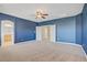 Large carpeted primary bedroom with connecting bathroom and closets at 8005 Egypt Meadows Ave, Las Vegas, NV 89178