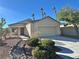 Single-story house with attached garage, landscaping, and desert landscaping at 10199 Spider Rock Ave, Las Vegas, NV 89135