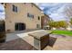 Large backyard patio with grill and fire pit at 10658 Salmon Leap St, Las Vegas, NV 89183