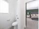 Modern bathroom with toilet and sink, plus a view into a bedroom beyond at 10658 Salmon Leap St, Las Vegas, NV 89183