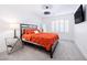 Bright bedroom with orange bedding, and a mirrored side table at 10658 Salmon Leap St, Las Vegas, NV 89183