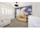 Bedroom with crib and whimsical night sky mural at 10658 Salmon Leap St, Las Vegas, NV 89183