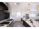 Modern kitchen features a stainless steel stove, marble countertops, an island, and a large window at 10658 Salmon Leap St, Las Vegas, NV 89183
