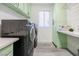 Clean and spacious laundry room with modern washer, dryer, and built-in storage at 10658 Salmon Leap St, Las Vegas, NV 89183