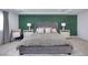 Main bedroom features a large bed and green accent wall at 10658 Salmon Leap St, Las Vegas, NV 89183