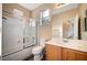 Bathroom with shower/tub combo, vanity, and a mirror at 11740 Via Esperanza Ave, Las Vegas, NV 89138