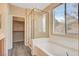 Bathroom with a bathtub, shower and large window at 11740 Via Esperanza Ave, Las Vegas, NV 89138