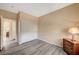 Bedroom with double door closet and wood-look flooring at 11740 Via Esperanza Ave, Las Vegas, NV 89138