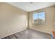 Bright bedroom with large window, wood-look flooring, and neutral walls at 11740 Via Esperanza Ave, Las Vegas, NV 89138