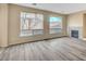 Gathering room with gray flooring, a fireplace and large windows at 11740 Via Esperanza Ave, Las Vegas, NV 89138