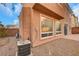Rear view of two-story house with large windows and AC unit at 11740 Via Esperanza Ave, Las Vegas, NV 89138