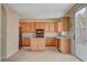 Eat-in kitchen, island, wood cabinets, and tile floors at 11740 Via Esperanza Ave, Las Vegas, NV 89138
