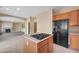 Spacious kitchen features an island with gas cooktop, ample cabinetry, and a large refrigerator at 11740 Via Esperanza Ave, Las Vegas, NV 89138