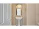 Elegant powder room with pedestal sink and neutral color palette at 11740 Via Esperanza Ave, Las Vegas, NV 89138