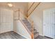 Modern staircase with wooden railing and gray laminate flooring at 11740 Via Esperanza Ave, Las Vegas, NV 89138