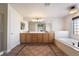 Bathroom boasts double vanity, soaking tub, and tile floors at 126 Cricklewood Ave, Henderson, NV 89002