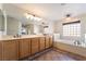 Double vanity bathroom with a garden tub and tile flooring at 126 Cricklewood Ave, Henderson, NV 89002