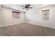 Well-lit bedroom with two windows, ceiling fan and neutral carpet at 126 Cricklewood Ave, Henderson, NV 89002