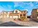 Two-story house with three-car garage and desert landscaping at 126 Cricklewood Ave, Henderson, NV 89002